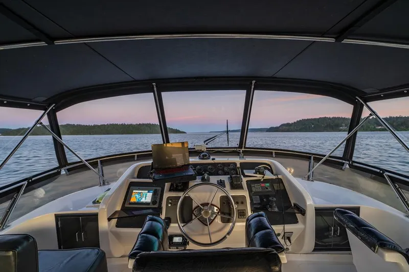 Slide: The Image of Cockpit view of 1990 Ocean Alexander 48 Cockpit Motoryacht at sunset on open water. - 36