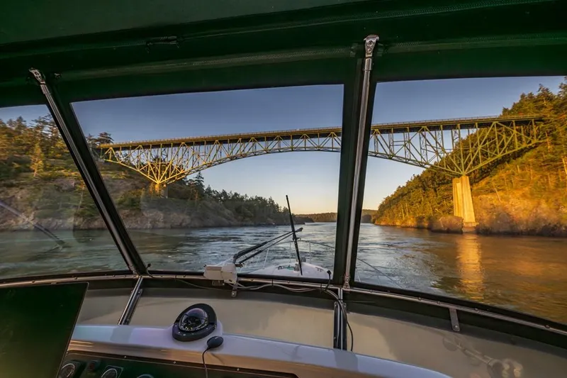 Slide: The Image of View from 1990 Ocean Alexander 48 Cockpit Motoryacht under a scenic bridge at sunset. - 38