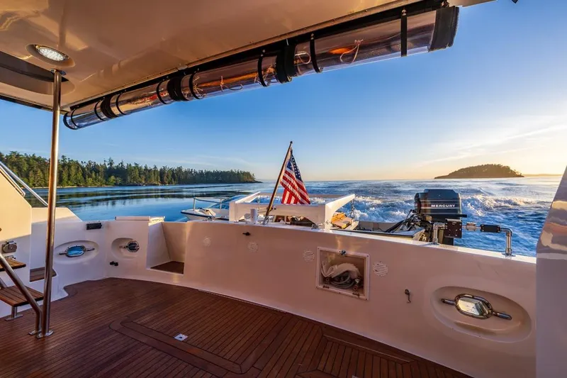 Slide: The Image of Ocean Alexander 48 Cockpit Motoryacht, 1990, cruising at sunset with scenic ocean view. - 42