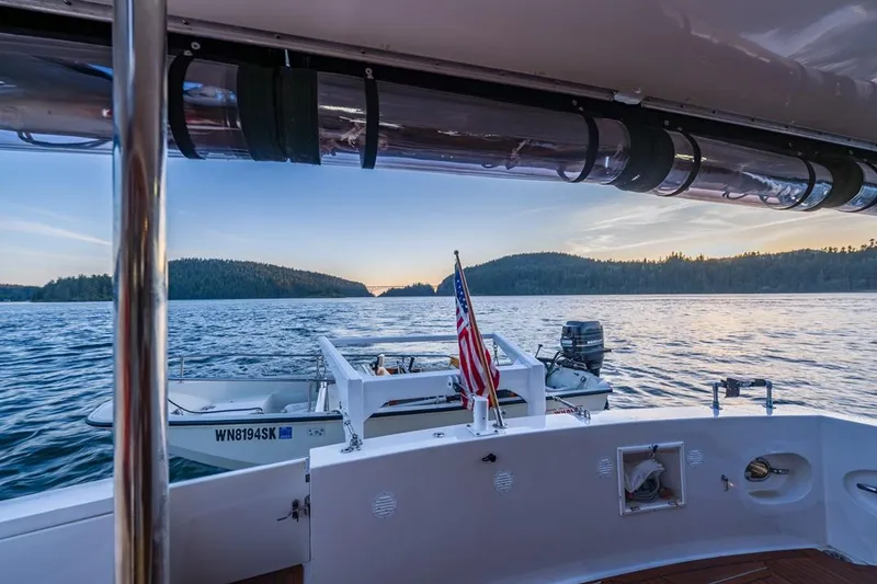 Slide: The Image of 1990 Ocean Alexander 48 Cockpit Motoryacht on serene water at sunset. - 44