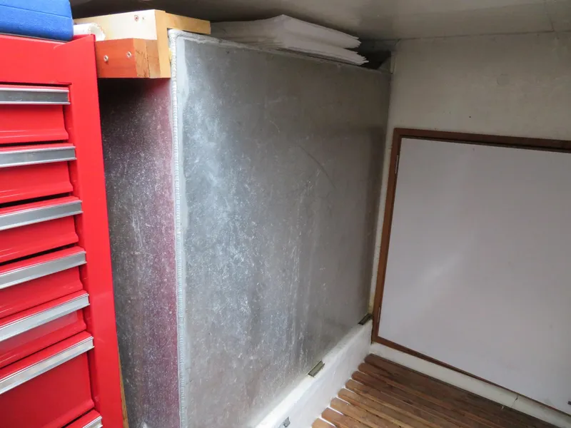 Slide: The Image of Interior of 1990 Ocean Alexander 48 Cockpit Motoryacht with red tool chest and storage area. - 47