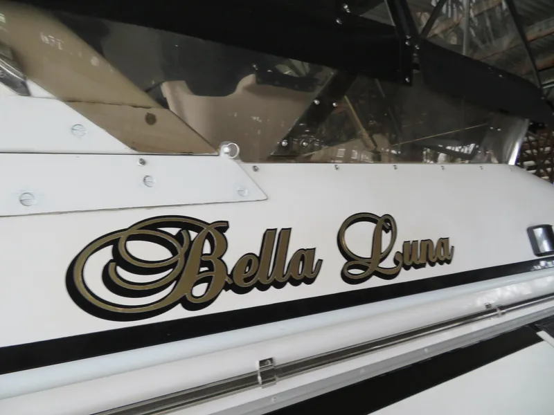 Slide: The Image of Ocean Alexander 48 Cockpit Motoryacht 1990, named "Bella Luna," docked in a marina. - 27