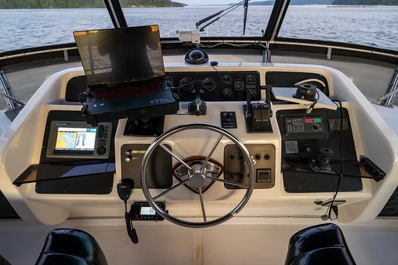 Slide: The Image of Cockpit of 1990 Ocean Alexander 48 Motoryacht with steering wheel and navigation equipment. - 35