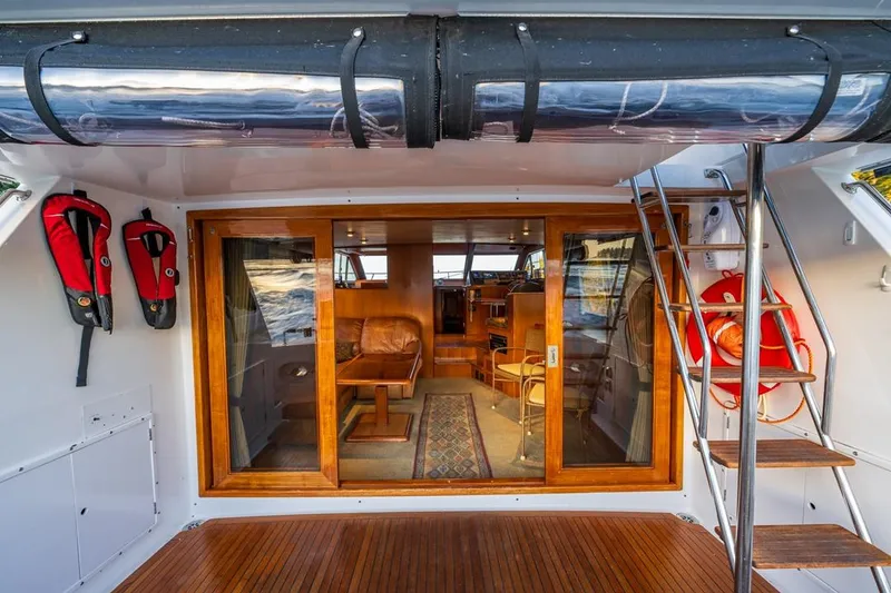 Slide: The Image of 1990 Ocean Alexander 48 Cockpit Motoryacht interior with wooden accents and safety equipment. - 39