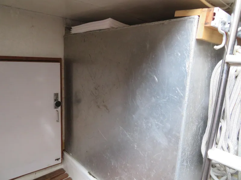 Slide: The Image of 1990 Ocean Alexander 48 Cockpit Motoryacht interior with metal panel and storage compartment. - 48