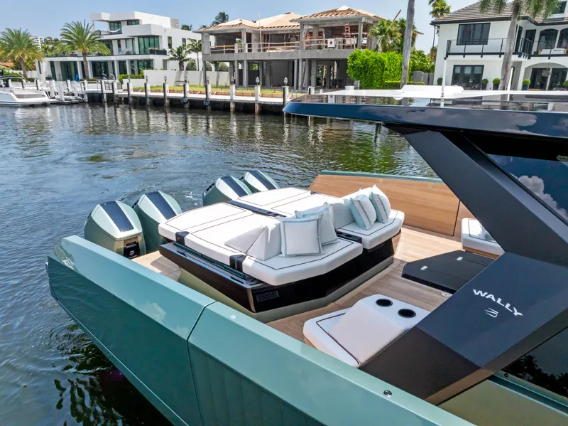 Slide: The Image of Luxurious 2024 Wally WALLYPOWER 58X yacht deck with elegant seating and scenic waterfront view. - 17