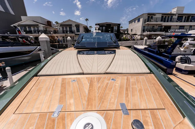 Slide: The Image of Luxurious 2024 Wally WALLYPOWER 58X yacht with plush seating, docked in a scenic marina. - 19