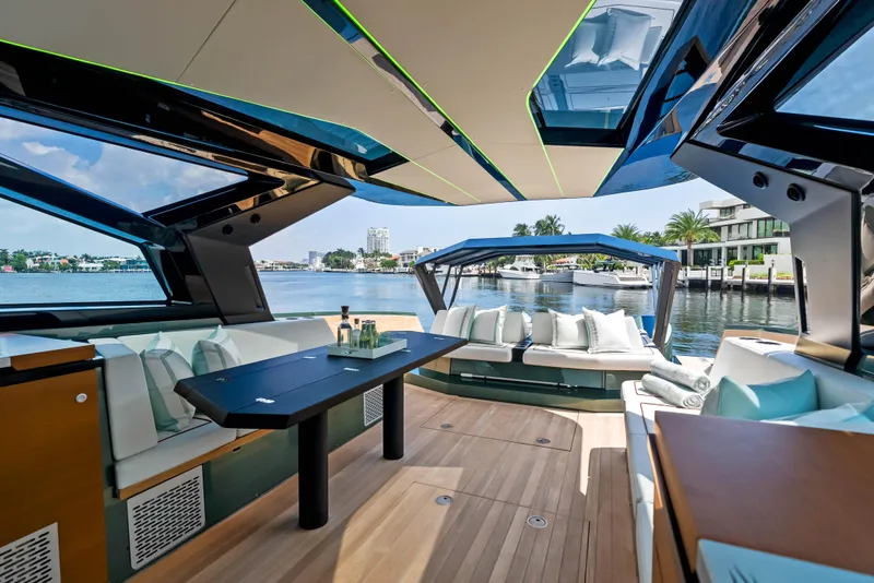 Slide: The Image of 2024 Wally WALLYPOWER 58X luxury yacht with sunbeds, docked near palm trees and waterfront homes. - 20