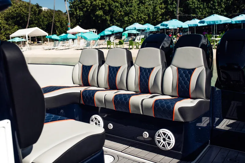 Slide: The Image of Luxury seating on 2014 Midnight Express 37' Open boat, with beach and umbrellas in background. - 12
