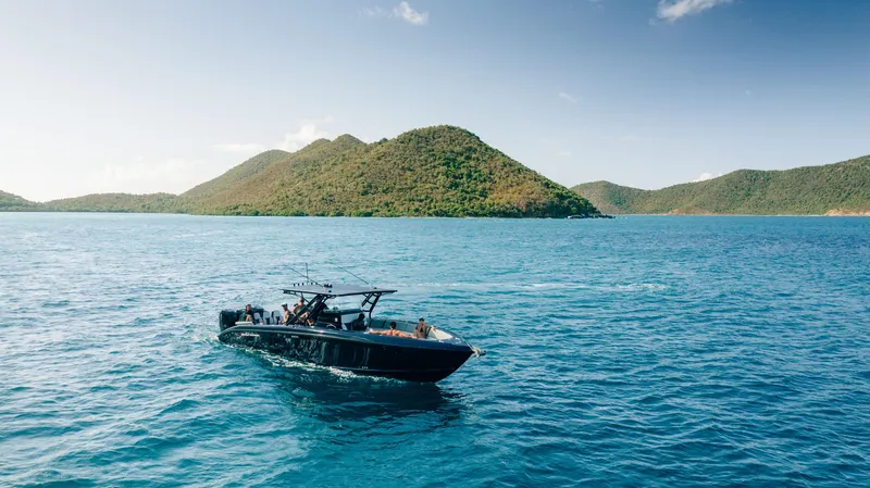 Slide: The Image of Midnight Express 37' Open 2014 boat cruising on blue ocean near lush islands. - 3