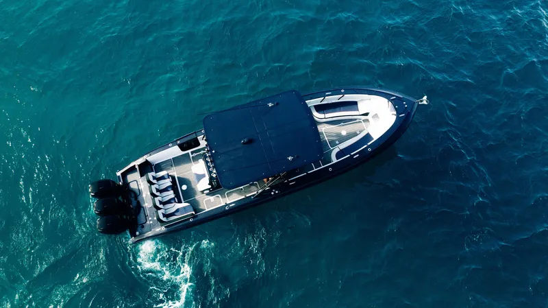 Slide: The Image of 2014 Midnight Express 37' Open boat cruising on blue ocean waters. - 4