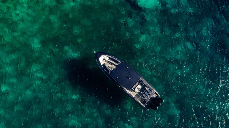Slide: The Image of Aerial view of 2014 Midnight Express 37' Open boat on clear turquoise water. - 6