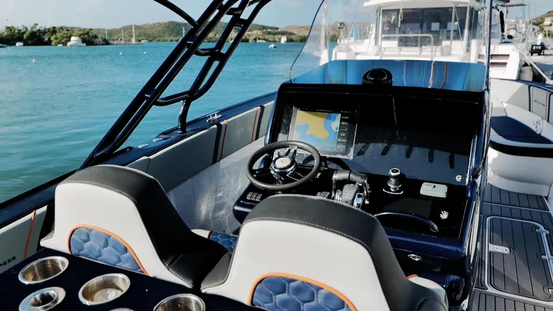 Slide: The Image of 2014 Midnight Express 37' Open boat interior with steering wheel and navigation system. - 8