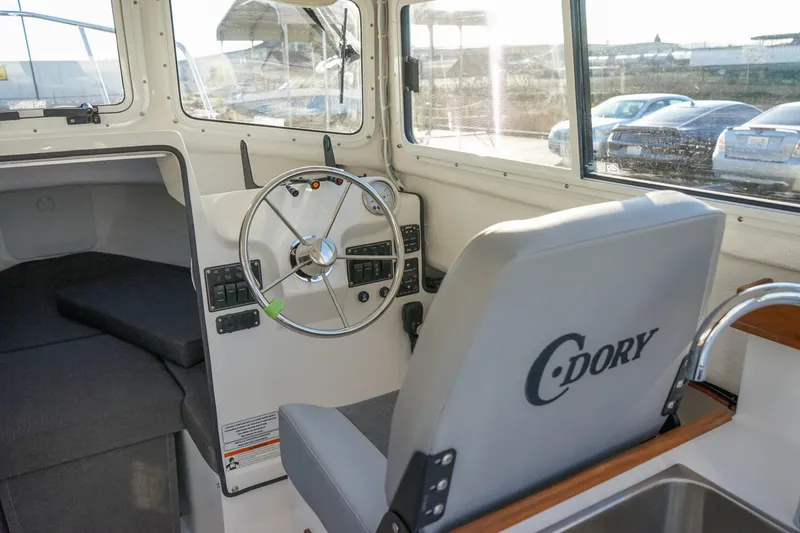 Slide: The Image of 2025 C-Dory 22' Cruiser interior with steering wheel and seating. - 10
