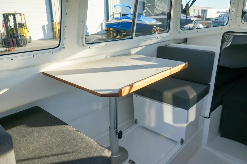 Slide: The Image of Interior of 2025 C-Dory 22' Cruiser with seating and table. - 13