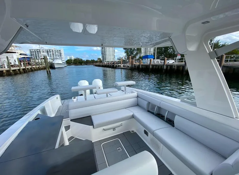 Slide: The Image of 2024 Aviara AV32 OB boat with spacious seating, docked in a scenic marina. - 13