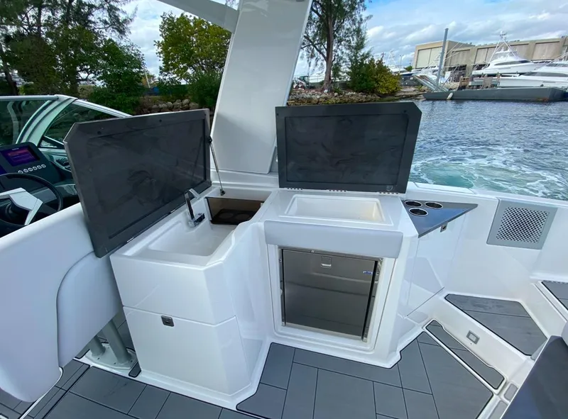 Slide: The Image of 2024 Aviara AV32 OB boat kitchen area with sink, stove, and storage. - 15