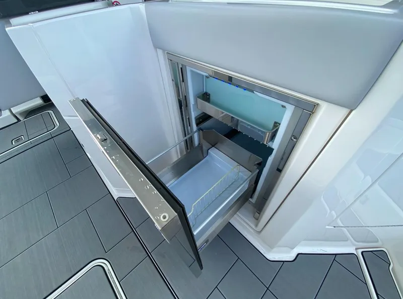 Slide: The Image of 2024 Aviara AV32 OB boat with open built-in drawer refrigerator. - 16