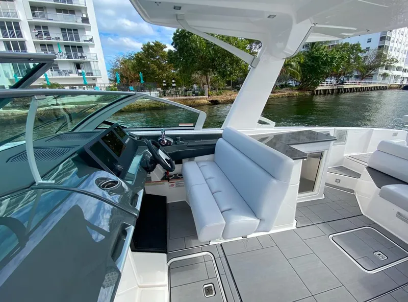 Slide: The Image of 2024 Aviara AV32 OB boat interior with modern seating and sleek dashboard design. - 17