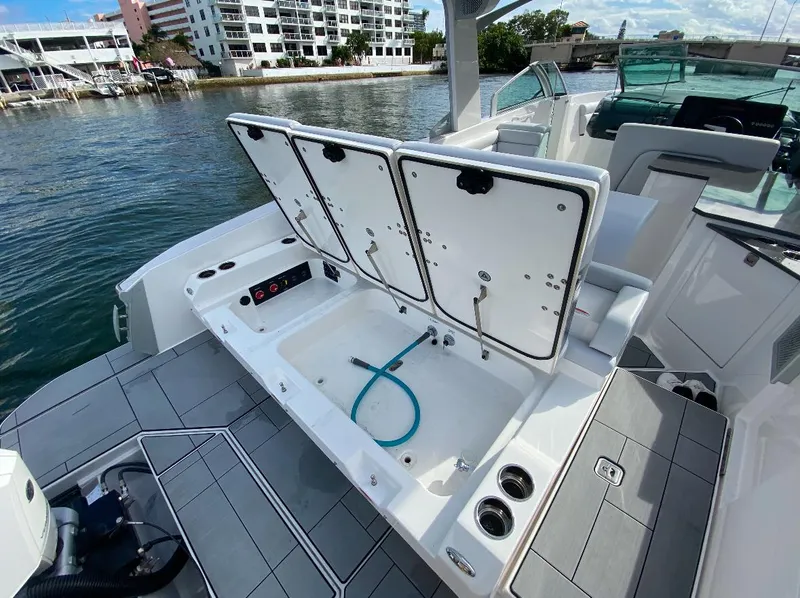 Slide: The Image of 2024 Aviara AV32 OB boat with open storage compartments on deck. - 4
