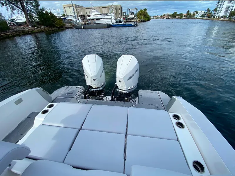 Slide: The Image of 2024 Aviara AV32 OB boat with twin outboard engines on a calm waterway. - 6