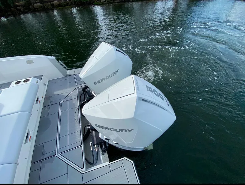 Slide: The Image of 2024 Aviara AV32 OB boat with dual Mercury outboard engines on water. - 7