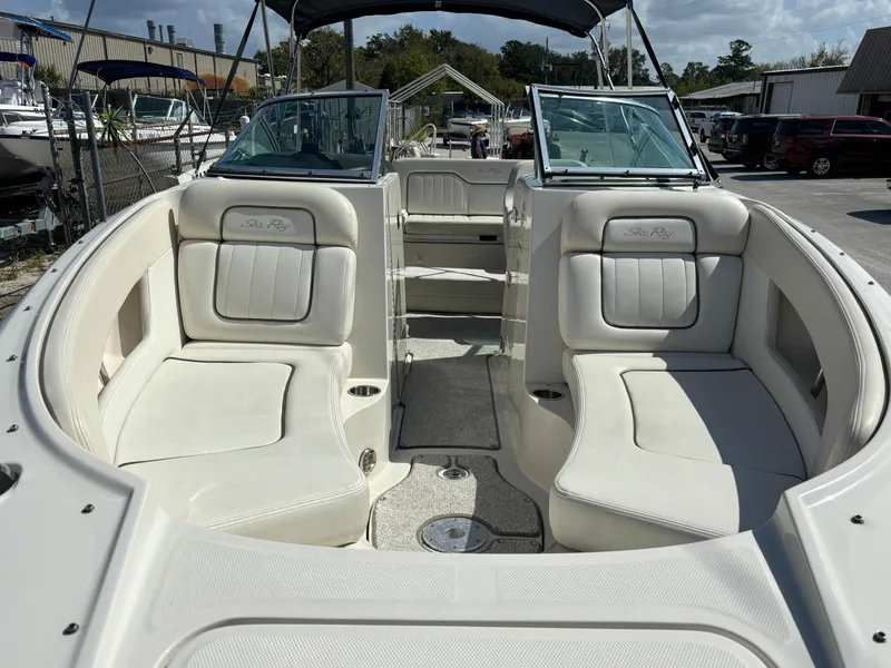 Slide: The Image of 2008 Sea Ray 230 Sundeck boat interior with white seating and open deck layout. - 11
