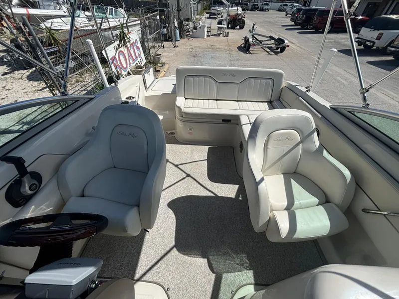 Slide: The Image of 2008 Sea Ray 230 Sundeck interior with seating and steering wheel. - 14
