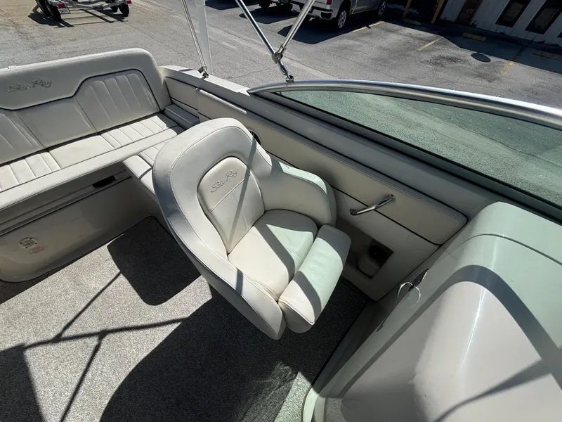 Slide: The Image of 2008 Sea Ray 230 Sundeck interior with white seating and carpeted floor. - 15