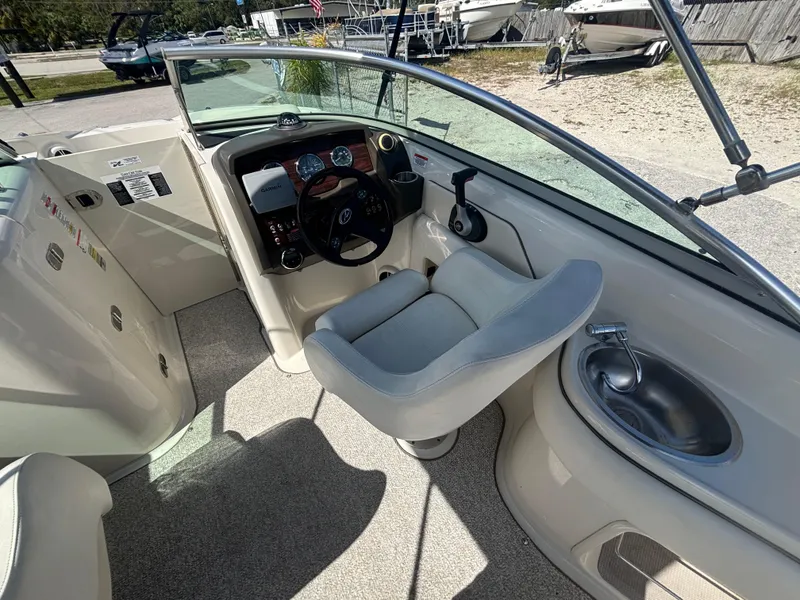 Slide: The Image of 2008 Sea Ray 230 Sundeck boat interior with steering wheel and seating area. - 19