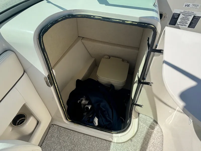 Slide: The Image of Storage compartment with portable toilet on 2008 Sea Ray 230 Sundeck boat. - 22
