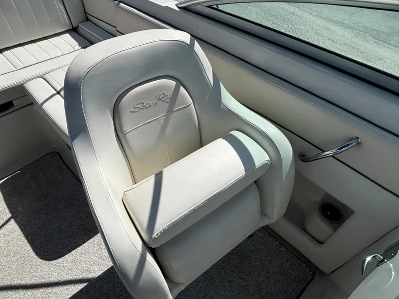Slide: The Image of 2008 Sea Ray 230 Sundeck boat interior with white seating and armrest. - 23