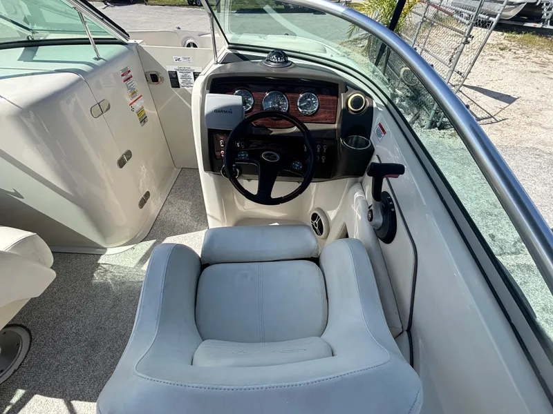 Slide: The Image of 2008 Sea Ray 230 Sundeck boat interior with steering wheel and dashboard. - 27