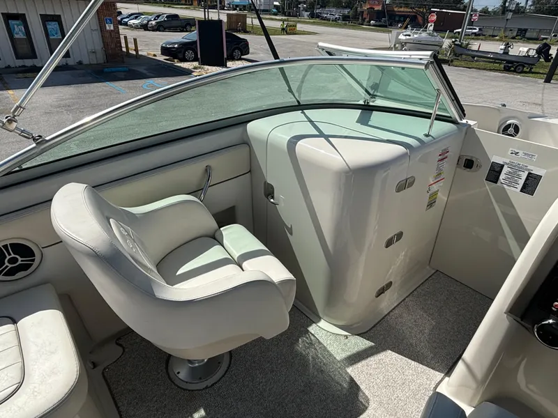 Slide: The Image of 2008 Sea Ray 230 Sundeck interior with helm and seating area. - 29