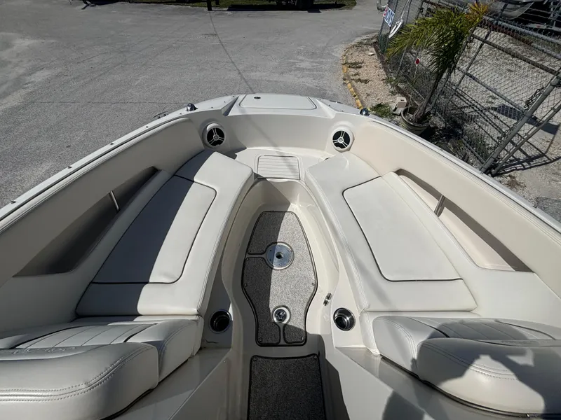 Slide: The Image of 2008 Sea Ray 230 Sundeck boat interior with white seating and cup holders. - 31