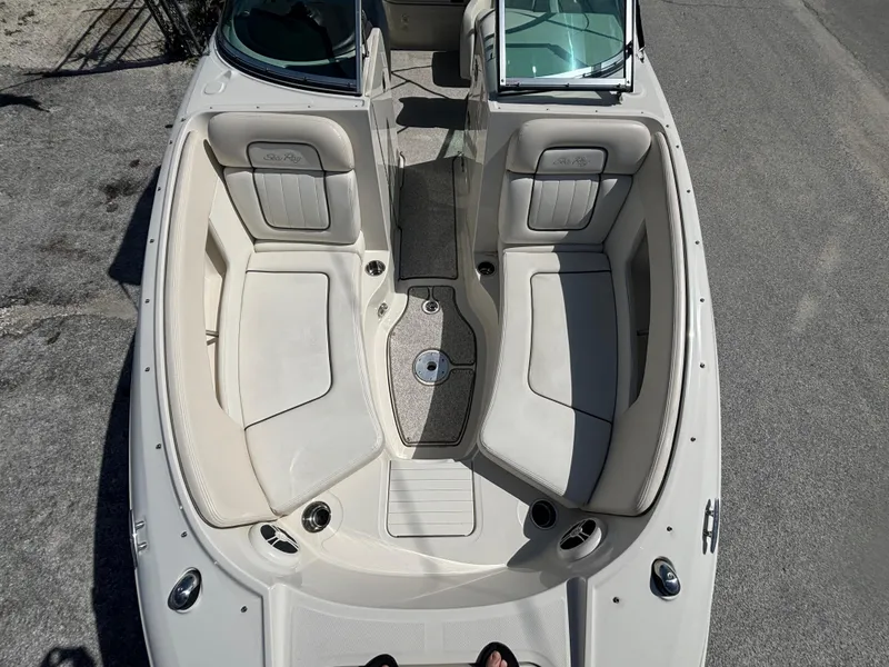 Slide: The Image of 2008 Sea Ray 230 Sundeck boat interior with spacious seating and cup holders. - 33