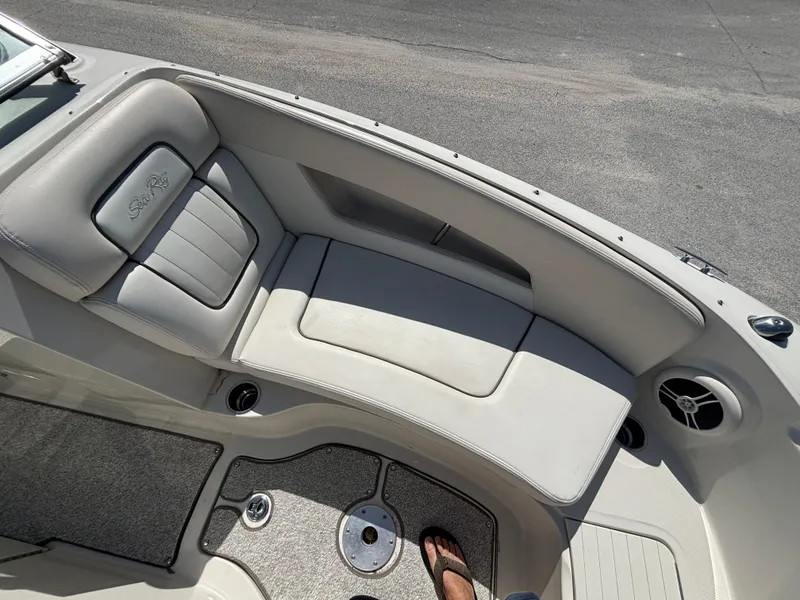 Slide: The Image of 2008 Sea Ray 230 Sundeck boat interior with cushioned seating and speaker. - 36