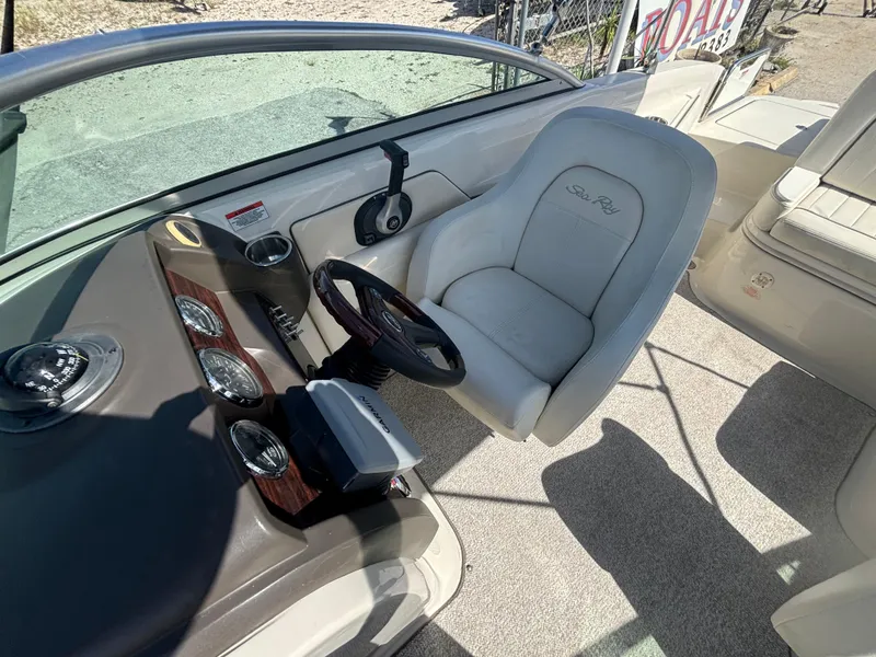 Slide: The Image of 2008 Sea Ray 230 Sundeck helm with steering wheel and captain's chair. - 38