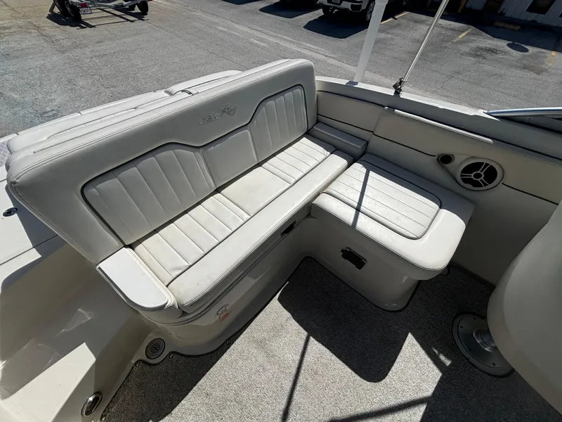 Slide: The Image of 2008 Sea Ray 230 Sundeck interior seating with white upholstery and spacious layout. - 39