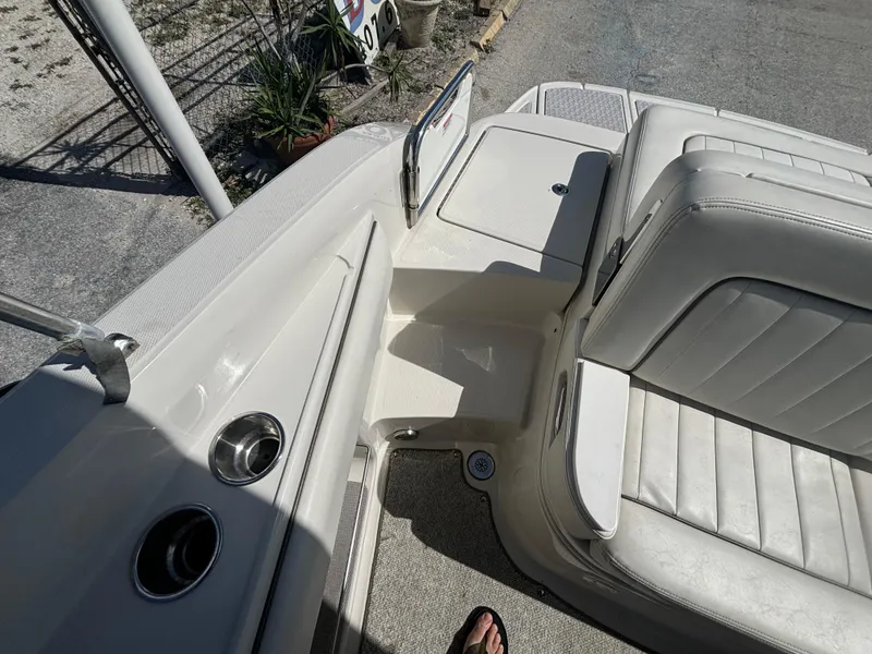 Slide: The Image of 2008 Sea Ray 230 Sundeck interior with white seating and cup holders. - 40
