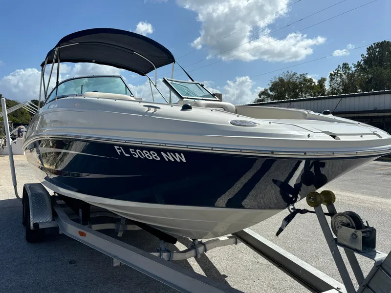 Slide: The Image of 2008 Sea Ray 230 Sundeck boat on trailer under clear sky. - 8