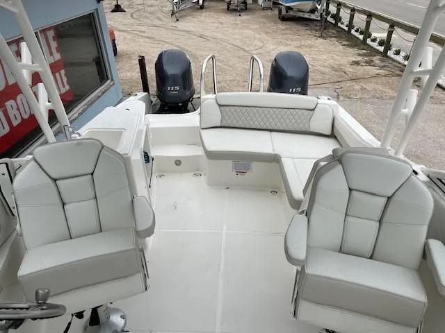 Slide: The Image of 2025 World Cat 230 SD boat interior with white seating and twin engines. - 5