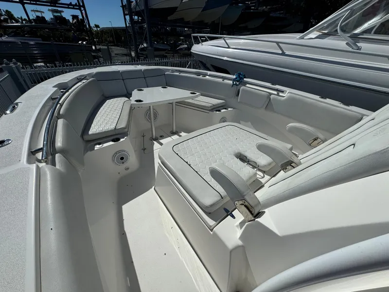 Slide: The Image of 2021 Sea Fox 328 Commander boat interior with cushioned seating and table. - 2