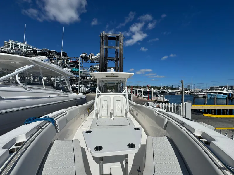 Slide: The Image of 2021 Sea Fox 328 Commander boat docked at a marina under a clear blue sky. - 5