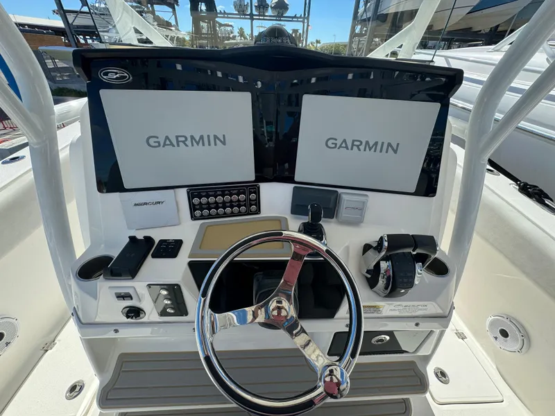 Slide: The Image of 2021 Sea Fox 328 Commander helm with dual Garmin displays and steering wheel. - 6