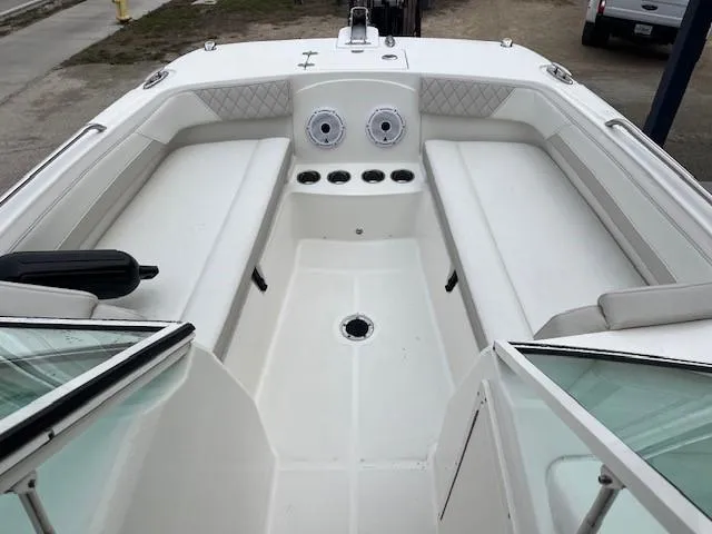 Slide: The Image of 2025 World Cat 230 DC boat interior with white seating and cup holders. - 4