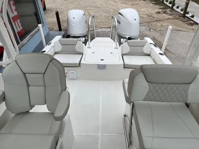 Slide: The Image of 2025 World Cat 230 DC boat interior with dual engines and cushioned seating. - 6