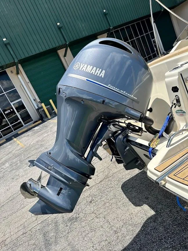Slide: The Image of 2023 Scout 215 Dorado with Yamaha outboard motor in a parking lot. - 13