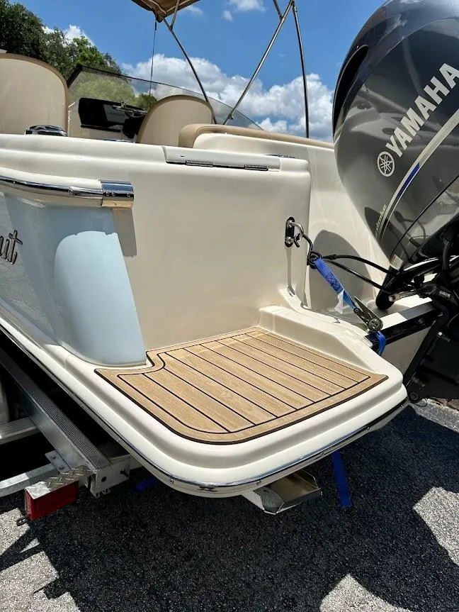 Slide: The Image of 2023 Scout 215 Dorado boat with Yamaha engine, featuring a teak swim platform. - 17
