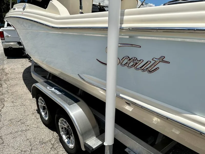 Slide: The Image of 2023 Scout 215 Dorado boat on trailer, side view with logo visible. - 18